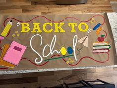 the back to school sign is hanging on the wall in front of a stove top