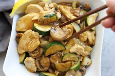 stir fry with mushrooms, zucchini and sliced cucumbers in a white bowl