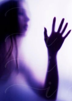 a blurry image of a woman holding her hand up