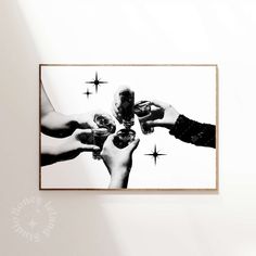 black and white photograph of four people holding wine glasses with stars on the wall behind them