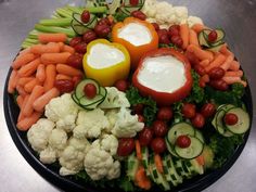 a platter filled with vegetables and dip