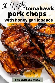 grilled pork chops with honey garlic sauce on a white plate