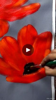 someone is painting red flowers with acrylic paint