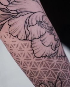 a woman's leg with flowers and triangles on the bottom half of her arm