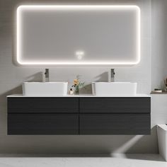 a modern bathroom with two sinks and a large mirror above the sink is illuminated by lights