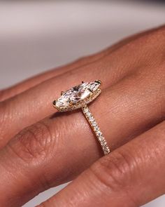 a woman's hand with a ring on it and a diamond in the middle