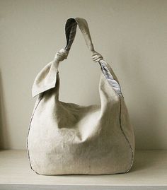 a white purse sitting on top of a shelf