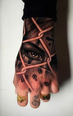 a person's hand with tattoos on it and an eye in the middle of their hand