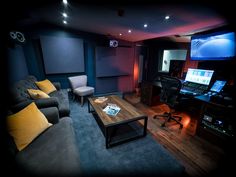 a living room filled with furniture and a flat screen tv mounted to the side of a wall