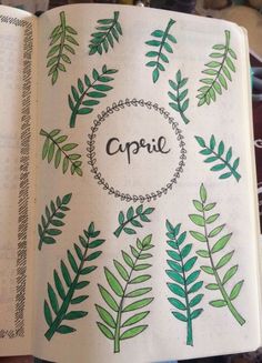 an open notebook with green leaves and the word capric written in black on it