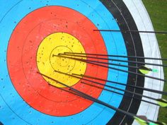 an overhead shot of arrows in the center of a target