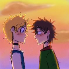 two young men standing next to each other in front of an orange and yellow sky