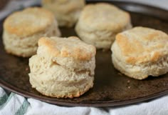 four biscuits on a plate with a white towel