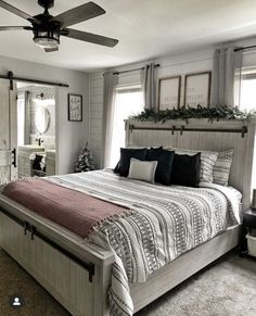 a bedroom with a bed, dresser and ceiling fan