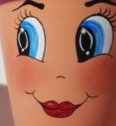 a close up of a cup with an image of a face on the bottom and blue eyes