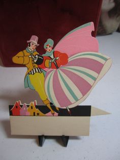 a card with an image of a clown holding a parasol on it's back