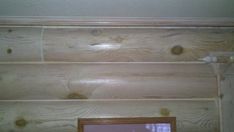 wood paneling on the wall with a mirror above it