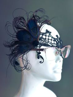 The beauty of peacock feathers in rare black shade combined with intricate black lace, designed to fit comfortably over glasses. Perfect for those who want to add a touch of sophistication and mystery to their look while keeping their eyewear on. Make a striking impression with your glasses on!


Age Group/Gender - Adult/Women

Size/Type - One size fits all adults

Mask Color - Black

Mask Material - Lace & Feathers White Feather Mask, Kids Party Packs, Metal Mask, Feather Mask, Female Mask, Lace Mask, Eye Glass, White Feather, 1920s Flapper