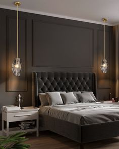 a bedroom with a large bed and two hanging lights