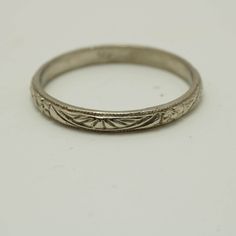 an antique silver wedding ring on a white background