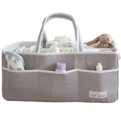 a diaper caddy filled with baby items and a stuffed animal in the back