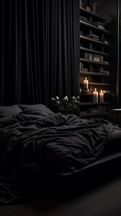 a dark bedroom with candles lit up on the windowsill and a bed covered in black sheets