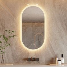 a bathroom with a round mirror on the wall and a plant in front of it