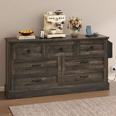 an old dresser with drawers and a coffee maker on top