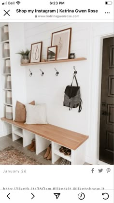 a white bench with some pictures hanging on the wall and a purse sitting on top of it