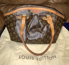 Stunning Louis Vuitton Tivoli GM Made in FRANCE! CODE # SD4098 This is a RARE and DISCONTINUED SIZE! This is an opportunity to own this GORGEOUS handbag that you will never find again! Comes with dust bag! With adjustable handles, you can use it as a handbag or make it a shoulder bag. With a Louis Vuitton Medallion charm attached, this bag also zips closed for. There are five bottom studs on the base of the bag for protection. CONDITION: The bag is in a fair pre-loved condition. The monogram canvas and the interior lining are clean. The leather vachetta has a beautiful light honey patina. SIGNS OF STAINS AND DISCOLORATION INSIDE AND OUTSIDE  CANVAS AND LEATHER The interior has stains consistent with use, the exterior has stains consisted with use. The exterior has scuffs, scratches, discol Louis Vuitton Tivoli, Gm Monogram, Pre Owned Louis Vuitton, Monogram Handbag, Monogram Canvas, Made In France, Bags Handbags, Patina, Dust Bag