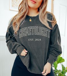 "This personalized year \"Cosmetologist EST. 2024\" sweatshirt would make the perfect graduation or appreciation gift for makeup artists, hair stylists and other cosmetologists! Want this in a t-shirt instead? You can find it here: https://www.etsy.com/listing/1714159539 *HOW TO ORDER* 1. Look through photos at the different colors and the sizing chart (all shirts & sweatshirts are unisex!) 2. Select your size and color from the drop down menus. 3. Choose the quantity you want in that size and c Outfits For Cosmetology School, Dress Code Friendly Outfits, Cosmetology Graduation, Cosmetologist Gifts, Friendly Outfits, Cosmetology School, Comfort Colors Sweatshirt, Grad Photos, Hair Stylists