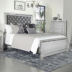 a bedroom with a bed, dressers and mirror in it's center area