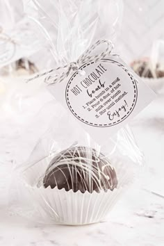 two chocolates wrapped in cellophane on a table