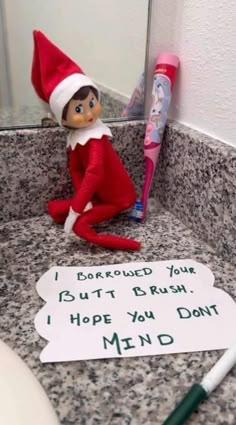 an elf is sitting in the bathroom sink next to a toothbrush and sign that says, i bought your bleash hope you don't mind