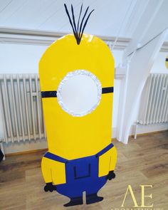 an inflatable yellow and blue minion costume sitting on top of a hard wood floor