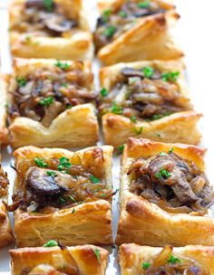 small pastries with mushrooms and parsley on a white plate, ready to be eaten