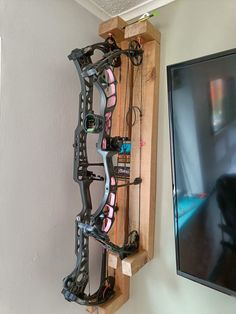 a bow rack mounted to the side of a wall