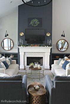 a living room filled with furniture and a flat screen tv mounted on the wall above a fireplace