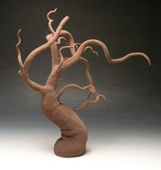 a clay sculpture of a tree with no leaves