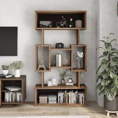 a living room filled with furniture and a flat screen tv on top of a wooden shelf