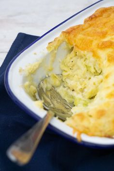 there is a casserole dish with broccoli and cheese in it on the plate