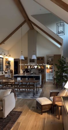 a living room filled with furniture next to a kitchen and dining room table in front of an open floor plan