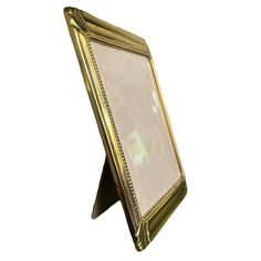 a gold frame with a white background is shown in this image, it looks like an old fashioned photo frame