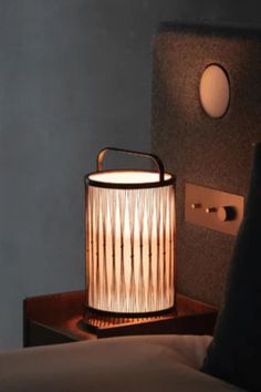 a lamp that is on top of a night stand