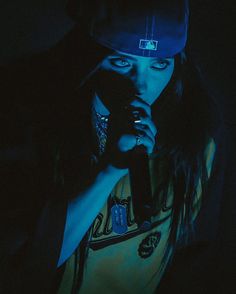 a woman holding a cell phone in the dark