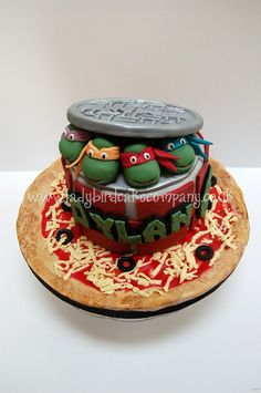 a birthday cake made to look like the teenage mutant turtles on top of a pizza