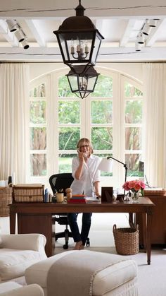 a woman sitting at a desk talking on the phone