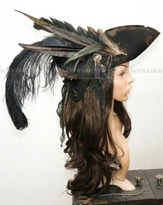 a wig with feathers on top of it