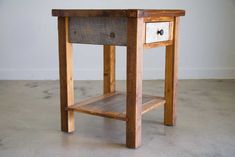 a small wooden table with two drawers on one side and an open drawer on the other