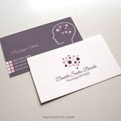 two business cards sitting on top of a white table with pink and purple flowers in the shape of a woman's head